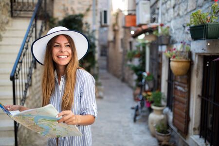 Happy young woman smiling and traveling at summer vacationの写真素材
