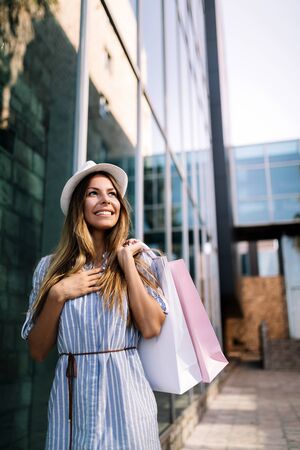 Beautiful young woman shopping and traveling on summerの写真素材