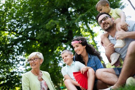 Happy family enjoying picnic in nature at summer
