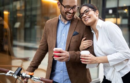Attractive young business couple embracing at streetの写真素材