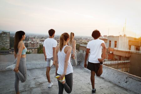 Fitness, sport, friendship and healthy lifestyle concept . Group of happy people exercisingの写真素材