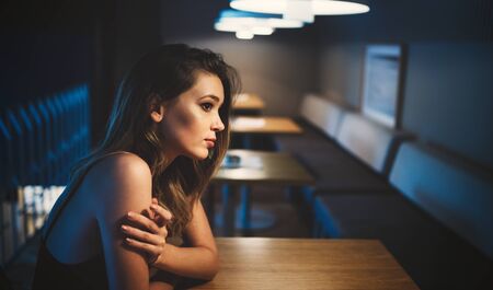 Portrait of attractive thoughtful pensive young womanの写真素材