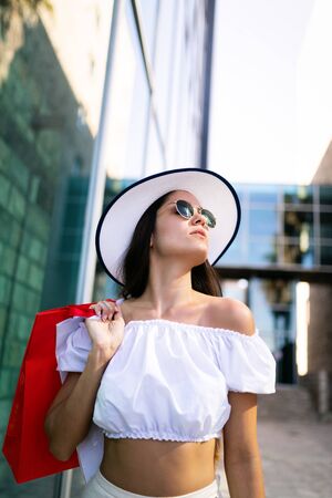 Beautiful woman with shopping bag. Sale, shopping, tourism and happy people conceptの写真素材