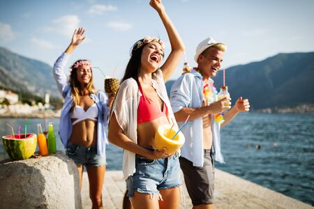 Group of friends having fun at summer party and drinking cocktailの写真素材