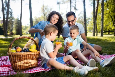 Cheerful happy family picnicking on a beautiful dayの写真素材