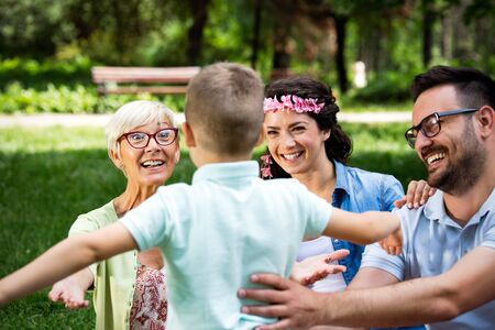 Happy young family enjoying picnic in natureの写真素材