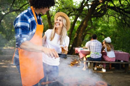 Group of friends having barbecue party in natureの写真素材