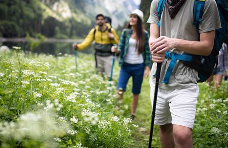 Group of happy friends with backpacks hiking togetherの写真素材