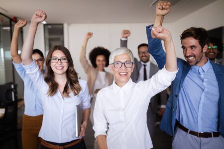 Happy business people celebrating success at company.の写真素材