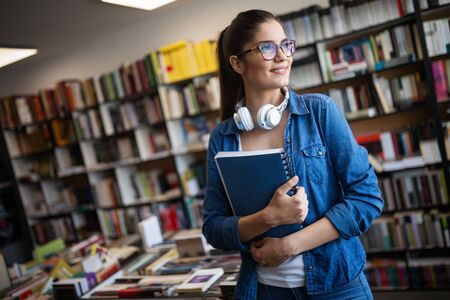 College woman studying at the library looking happyの写真素材