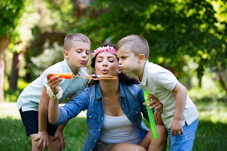 Happy young family enjoying picnic in natureの写真素材