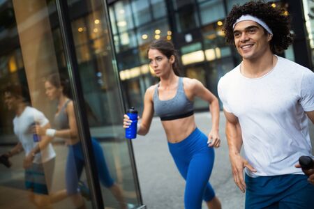 Couple jogging and running outdoors in city