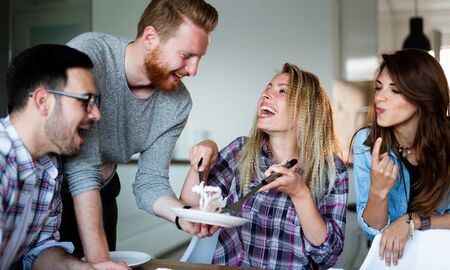 Birthday party with cake and candles friends celebrating togetherの写真素材