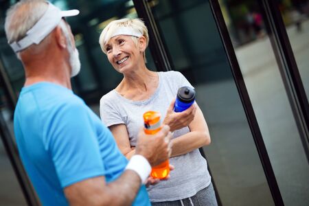 Beautiful sporty mature couple styaing fit with sport