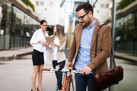 Business people discussing and smiling while walking together outdoorの写真素材