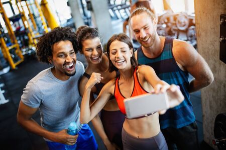 Group of sportive people in a gym taking selfie. Concepts about lifestyle and sport in fitness clubの写真素材