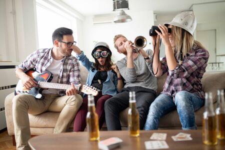 Group of young friends having fun together and playing in music bandの写真素材