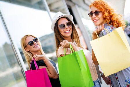 Beautiful women with shopping bags walking at the mallの写真素材