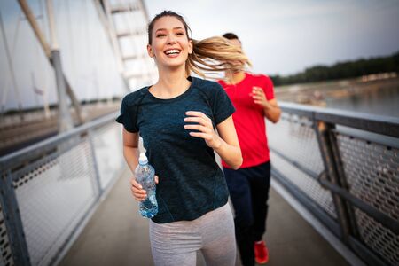 Friends fitness training together outdoors living active healthyの写真素材