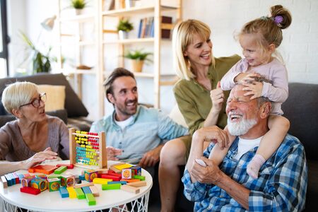 Senior grandparents playing with grandchildren and having fun with family
