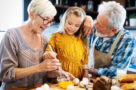 Happy grandparents having fun times with children at home