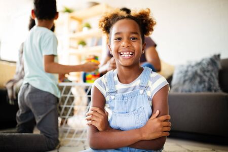 Portrait of a cute young african american girl smiling. Happy kid with familyの写真素材