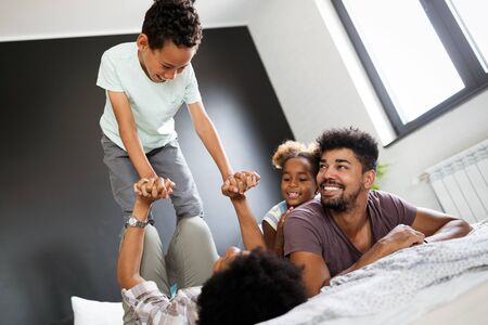 Happy black family having fun times at homeの写真素材