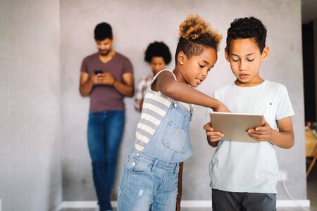 Family sharing there privacy data by using digital devices, phones, tabletsの写真素材