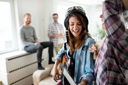 Group of friends having fun together, talking, laughing and enjoying their time.の写真素材