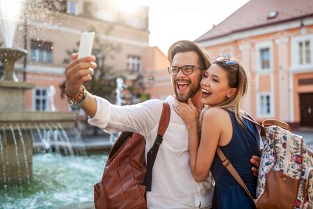 Happy tourist couple in love having fun, travel, smiling on vacationの写真素材