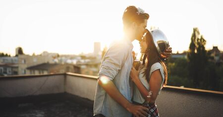 Couple flirting while having a drink on rooftop terrasseの写真素材