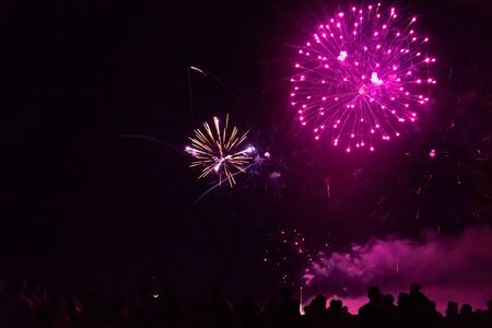 Crowd watching fireworks and celebrating new year eveの写真素材