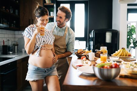 Beautiful happy lovely young couple expecting babyの写真素材