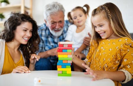 Happy family playing at home and having fun together.の写真素材
