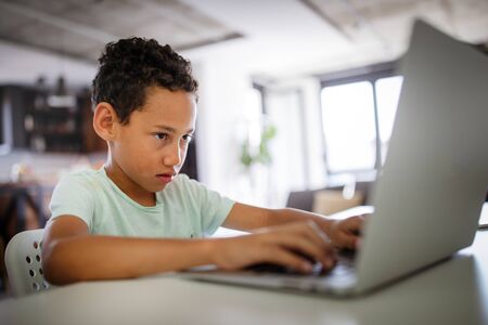 Boy spending time with notebook and modern technology
