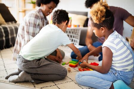 Happy black family having fun times at homeの写真素材