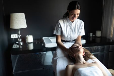 Massage, health, beauty and relaxation concept. Beautiful woman in spa salonの写真素材