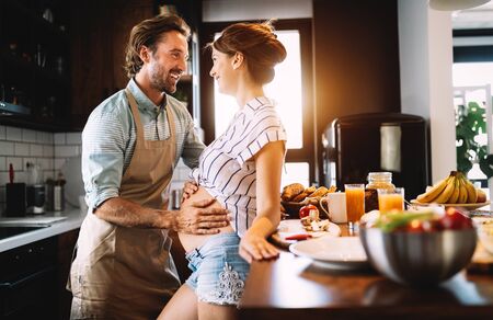 Beautiful happy lovely young couple expecting babyの写真素材