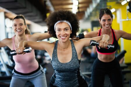 Fit sporty women exercising and training at fitness clubの写真素材