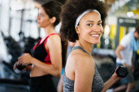 Fitness, sport, healthy and lifestyle concept. Smiling african american woman in gymの写真素材