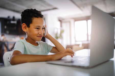 Boy spending time with notebook and modern technology