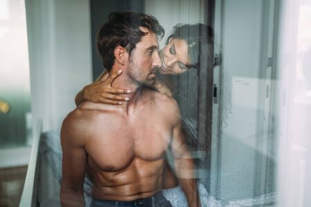Young sexy hot couple in love hugging and kissingの写真素材