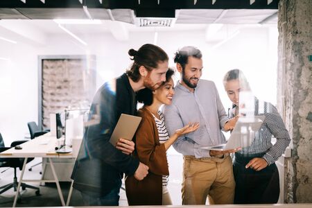 Group of business people collaborating on project in officeの写真素材