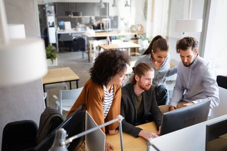 Cheerful coworkers in office during company meetingの写真素材