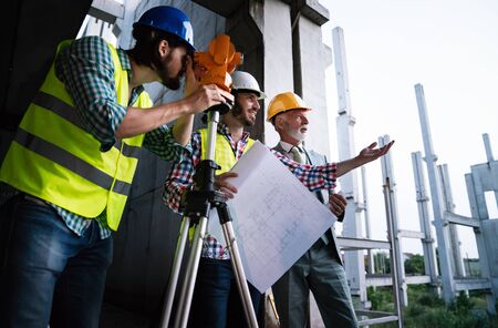 Architect and construction engineer or surveyor discussion plans and blueprints