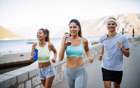 Outdoor portrait of group of friends running and jogging in natureの写真素材