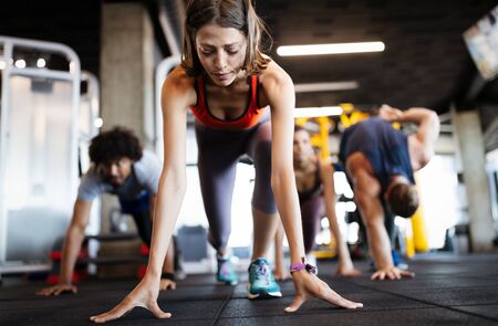 Beautiful fit people working out in gym togetherの写真素材