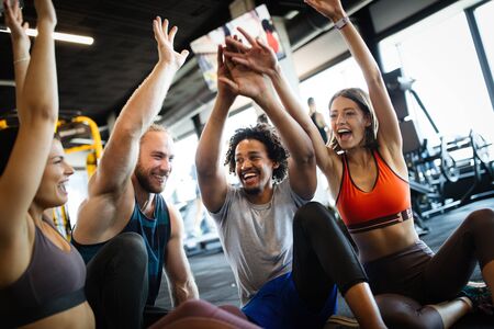 Healthy young athletes friends doing exercises at gym.の写真素材