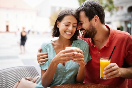 Cheerful young couple on a romantic date in a cafe.の写真素材