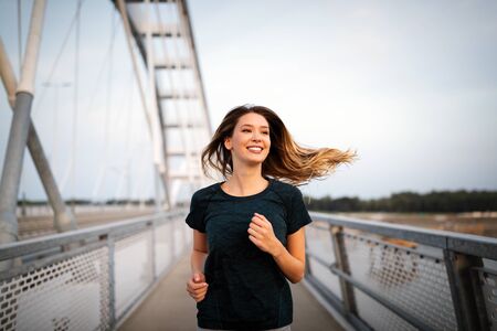 Sport, health, lifestyle and exercise concept. Sporty fit woman running.の写真素材